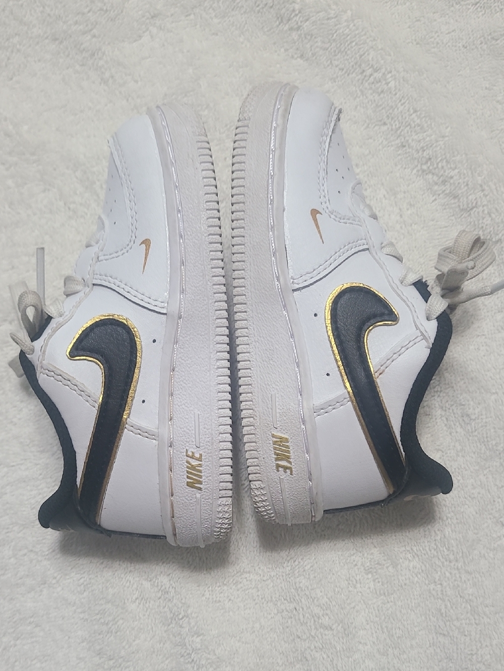 Nike White Sneakers with Black & Gold Swoosh